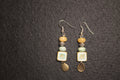 Handcrafted drop earrings with painted ceramic tile, stacked mixed beads, and antique gold teardrop charm