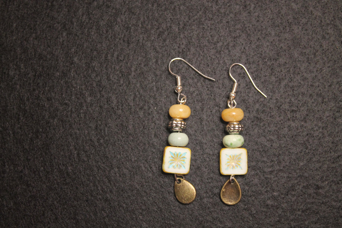 Handcrafted drop earrings with painted ceramic tile, stacked mixed beads, and antique gold teardrop charm