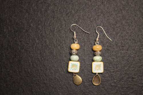 Handcrafted drop earrings with painted ceramic tile, stacked mixed beads, and antique gold teardrop charm